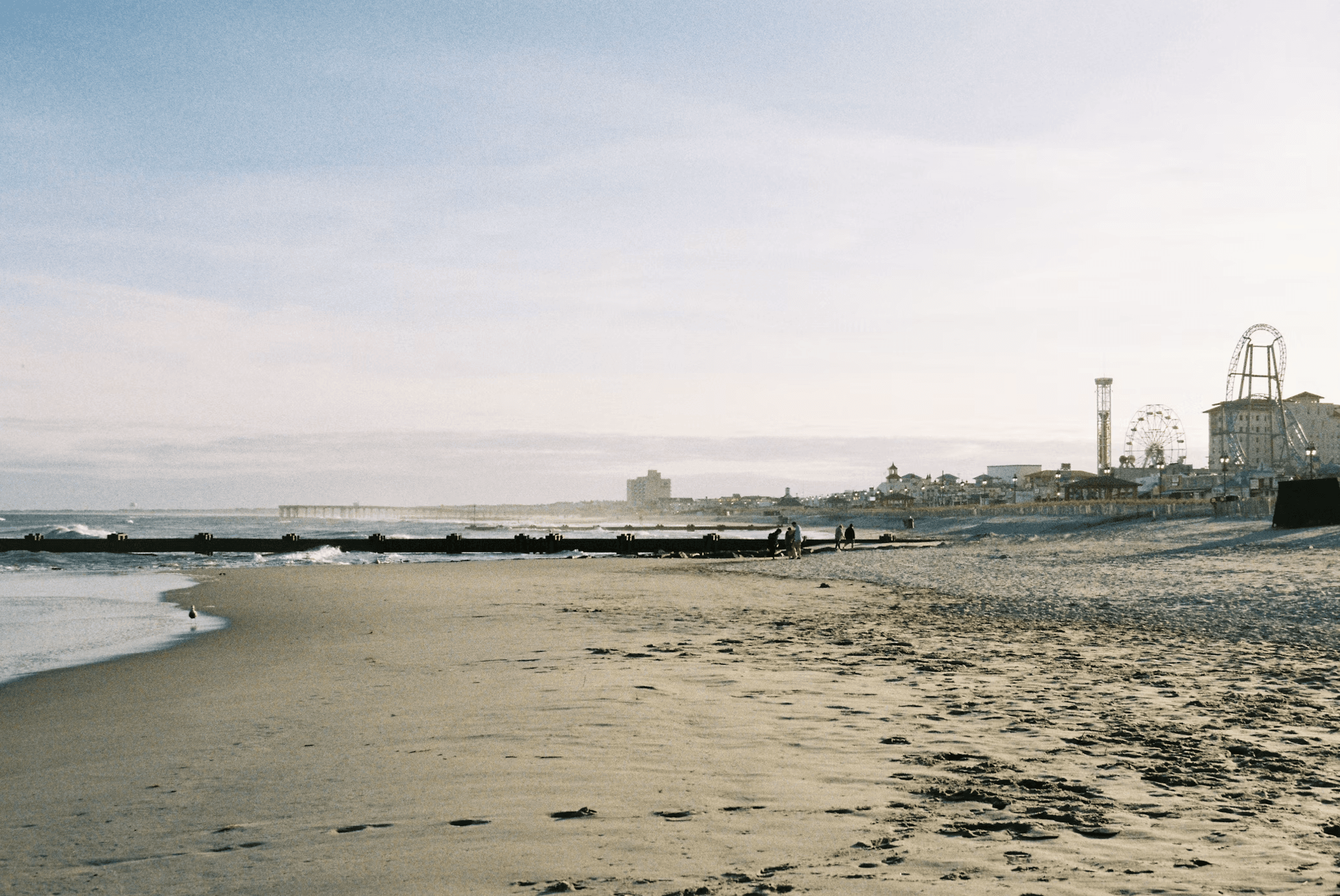 Ocean City, New Jersey beach with the boardwalk and amusement pier in the distance.